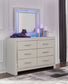 Zyniden King Upholstered Panel Bed with Mirrored Dresser, Chest and Nightstand